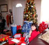 Christmas z Day 2012 - 1 Maureen in apartment opening gift from Kathy