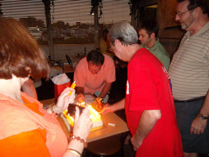 Mickey Kelley 60th B-Day - Mick Dan Kathy Rory lighting cake